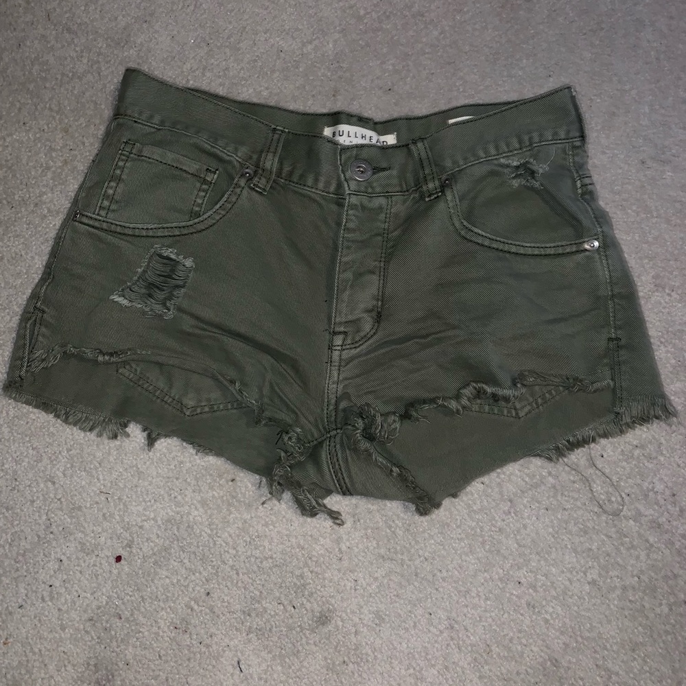 Army green distressed shorts.